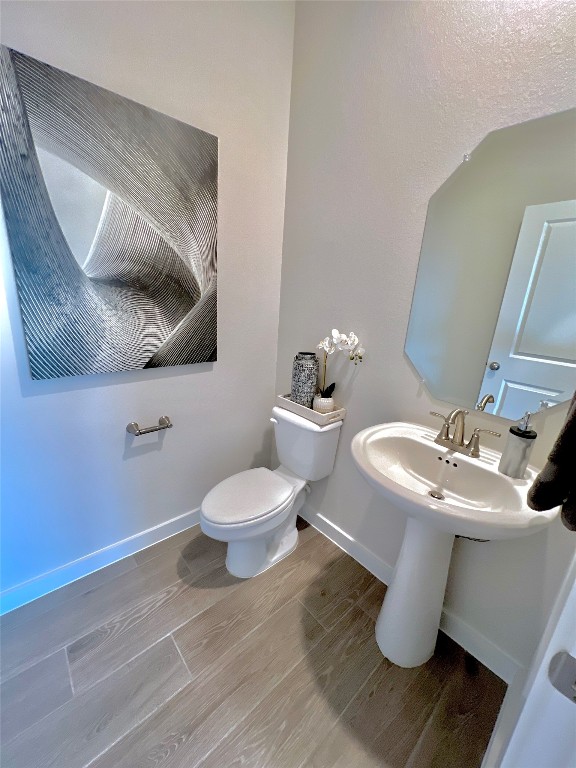 bathroom featuring toilet and hardwood / wood-style floors