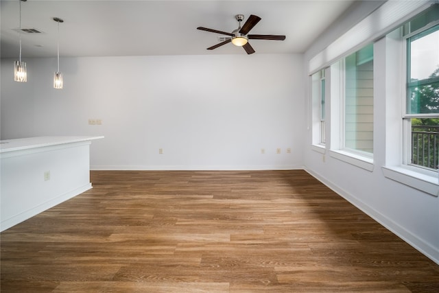 empty room with ceiling fan and hardwood / wood-style floors