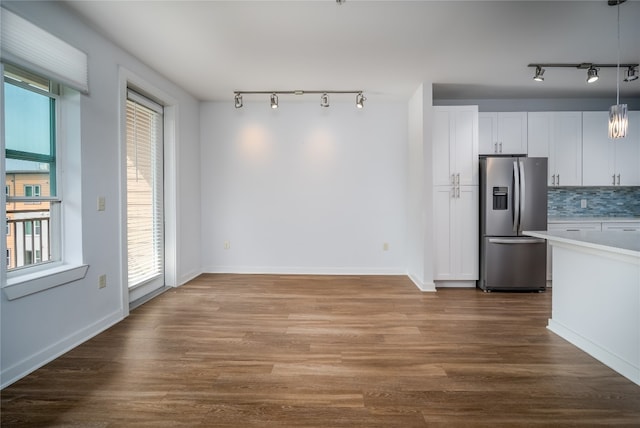 interior space featuring hardwood / wood-style flooring, track lighting, and a wealth of natural light