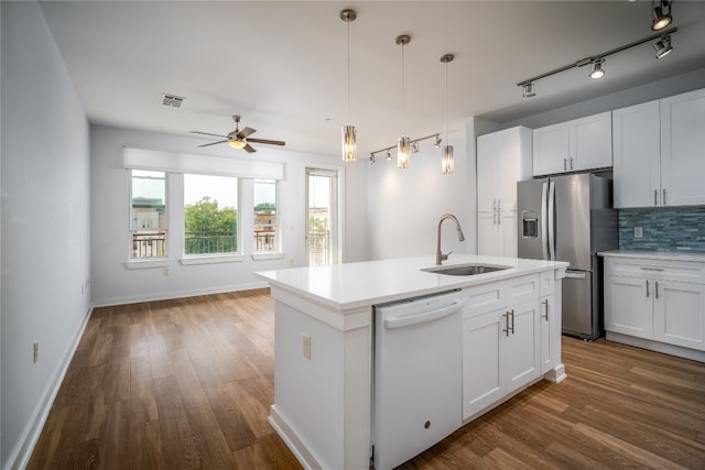 kitchen featuring stainless steel refrigerator with ice dispenser, sink, white cabinetry, white dishwasher, and a kitchen island with sink