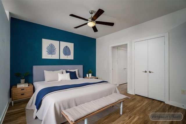 bedroom with baseboards, wood finished floors, a closet, and ceiling fan