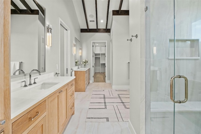 bathroom featuring vanity, beam ceiling, and walk in shower