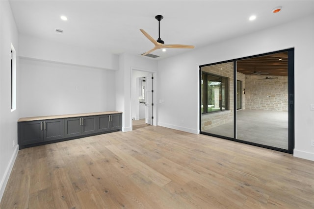 unfurnished living room featuring light wood-type flooring and ceiling fan