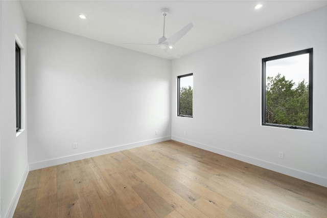 spare room featuring light wood-type flooring and ceiling fan