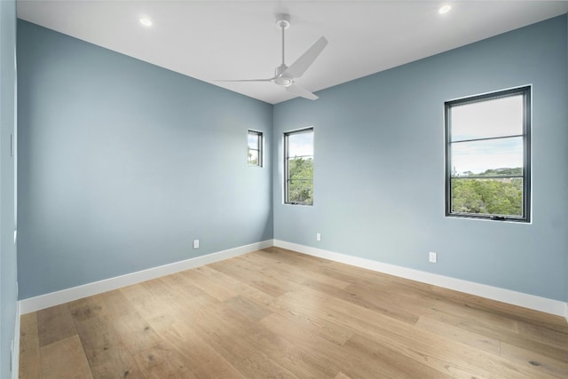 unfurnished room with light wood-type flooring and ceiling fan