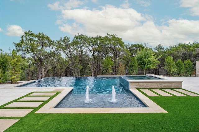 view of swimming pool with pool water feature, an in ground hot tub, and a lawn