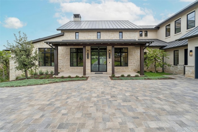 view of front of property featuring covered porch and a patio area