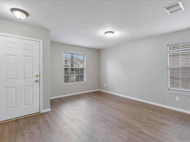 entryway with hardwood / wood-style flooring and a textured ceiling