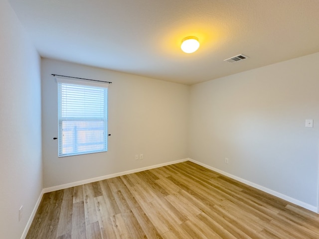 unfurnished room with light wood-type flooring