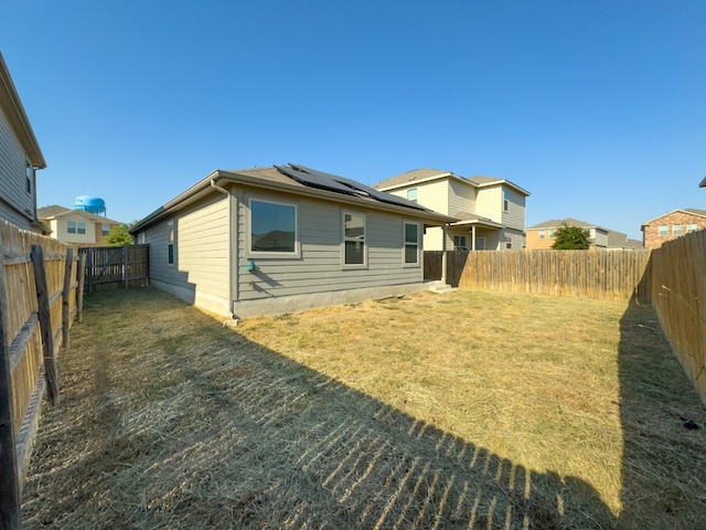 back of house featuring a yard