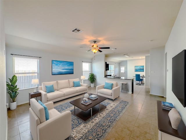 living room with ceiling fan, a healthy amount of sunlight, and light tile patterned flooring