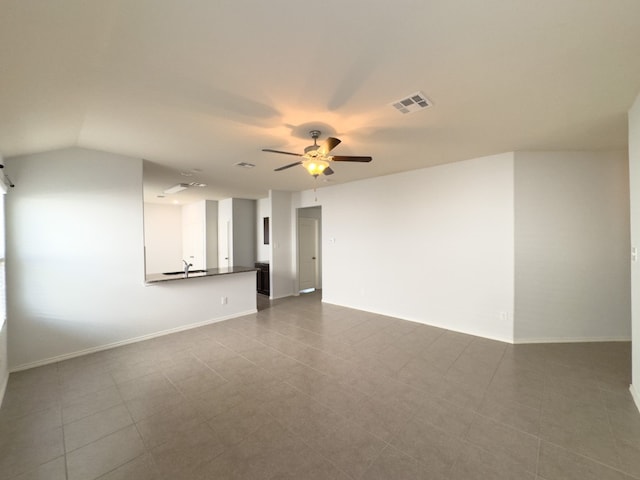 empty room featuring tile patterned floors, sink, lofted ceiling, and ceiling fan