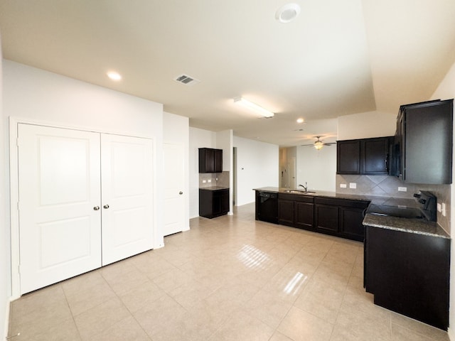 kitchen featuring sink, black appliances, ceiling fan, light tile patterned floors, and tasteful backsplash