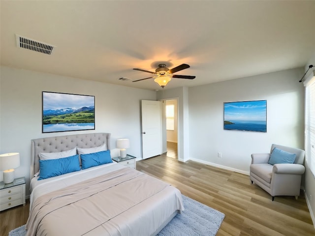 bedroom with light hardwood / wood-style floors and ceiling fan