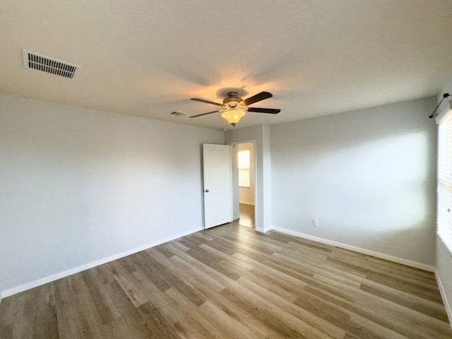 unfurnished room with ceiling fan and light wood-type flooring