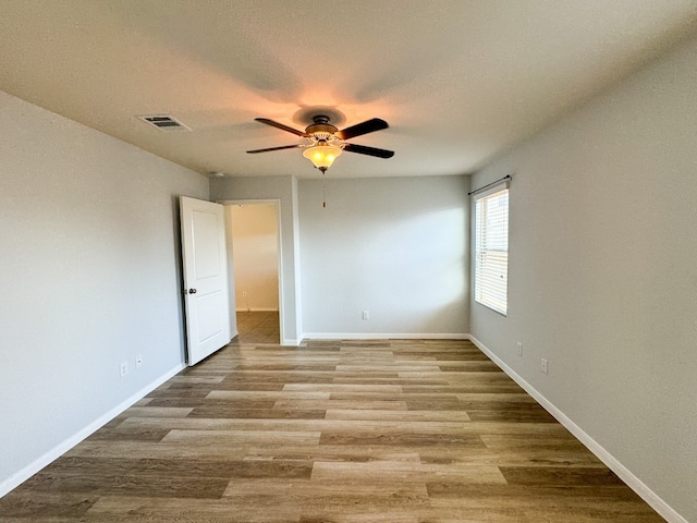 spare room with light hardwood / wood-style flooring and ceiling fan