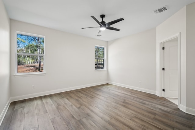 spare room featuring hardwood / wood-style flooring and ceiling fan