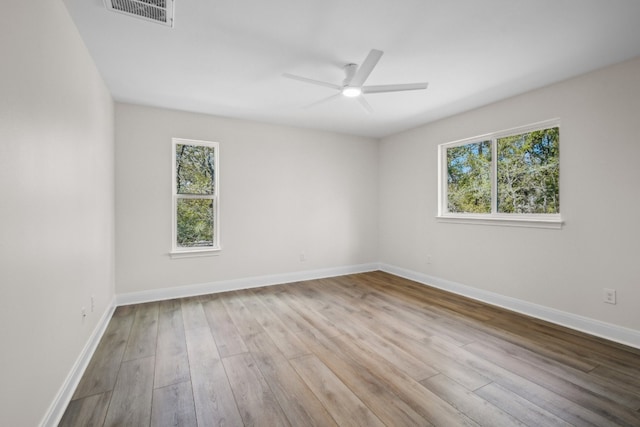 spare room featuring light hardwood / wood-style floors and ceiling fan