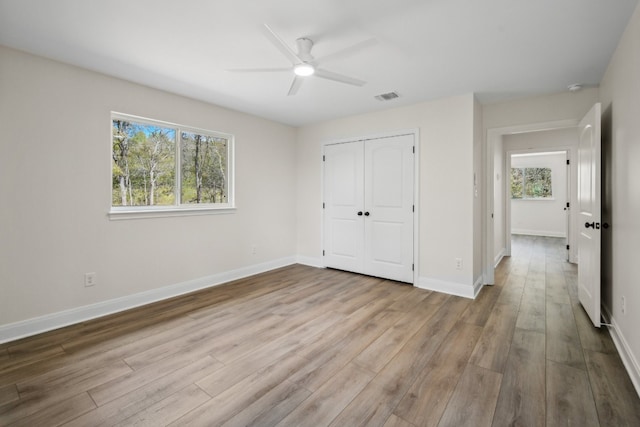 unfurnished bedroom with a closet, ceiling fan, and light hardwood / wood-style floors