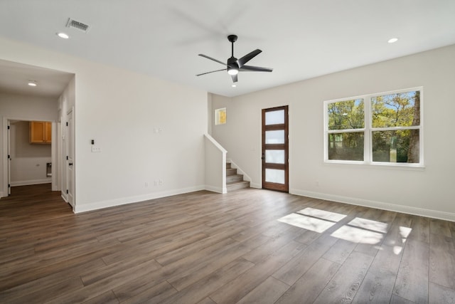 empty room with dark hardwood / wood-style floors and ceiling fan