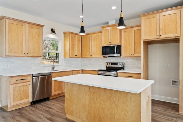 kitchen with a kitchen island, dark wood-type flooring, pendant lighting, light brown cabinetry, and appliances with stainless steel finishes