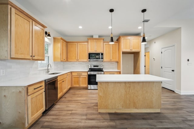 kitchen with appliances with stainless steel finishes, sink, light brown cabinetry, and light wood-type flooring