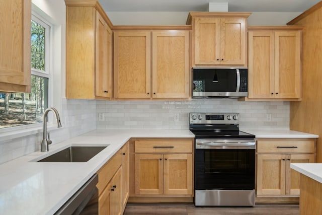 kitchen with light brown cabinetry, sink, backsplash, dark hardwood / wood-style flooring, and stainless steel appliances