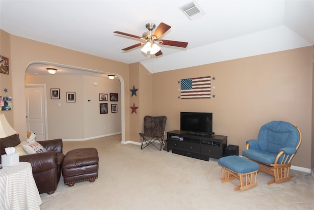 carpeted living room with ceiling fan