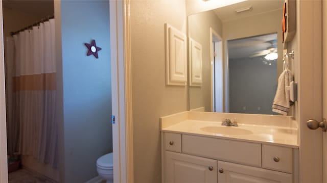 bathroom featuring vanity, toilet, and ceiling fan