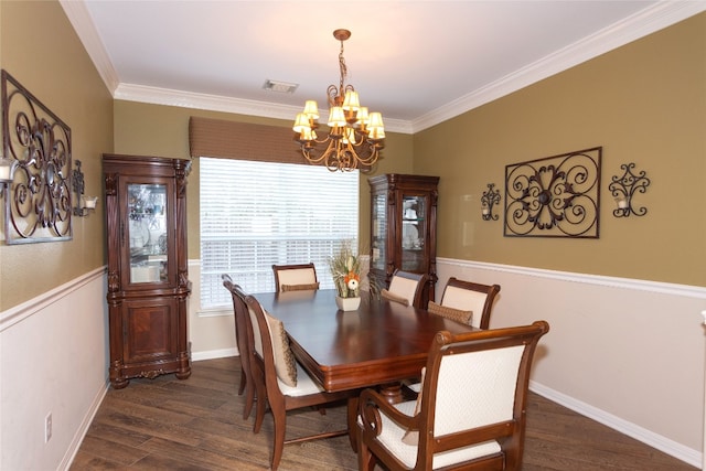 dining area featuring ornamental molding, a chandelier, and dark hardwood / wood-style flooring