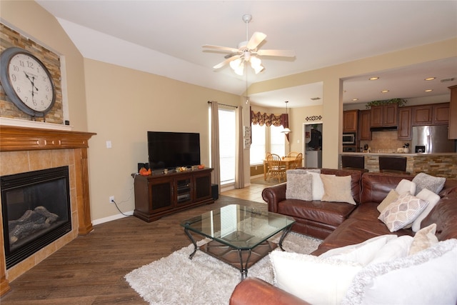 living room with hardwood / wood-style flooring, a fireplace, and ceiling fan