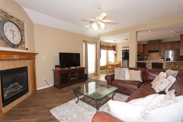 506 Fern Ct, Cedar Park, TX 78613 - living area featuring a ceiling fan, dark wood-style floors, a tiled fireplace, lofted ceiling, and recessed lighting
