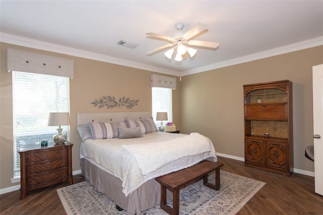 bedroom with crown molding, dark hardwood / wood-style floors, and ceiling fan