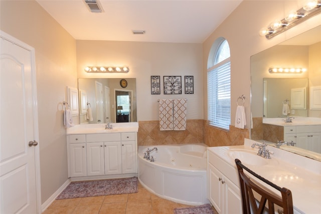 bathroom featuring vanity, a tub to relax in, and tile patterned floors