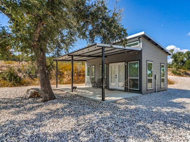 back of property featuring french doors and a patio