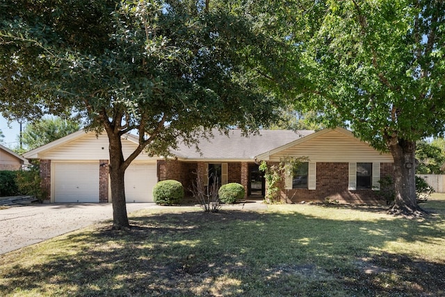 single story home featuring a garage and a front lawn