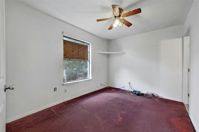 unfurnished room featuring ceiling fan, carpet floors, and a textured ceiling