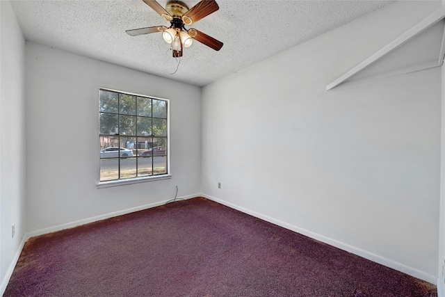 carpeted spare room with a textured ceiling and ceiling fan