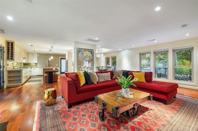 living room featuring wine cooler and light hardwood / wood-style floors