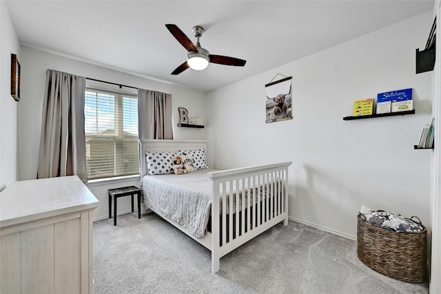 bedroom featuring ceiling fan and light carpet