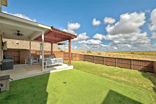 view of yard featuring a patio area and ceiling fan