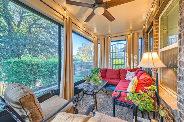 sunroom / solarium featuring ceiling fan