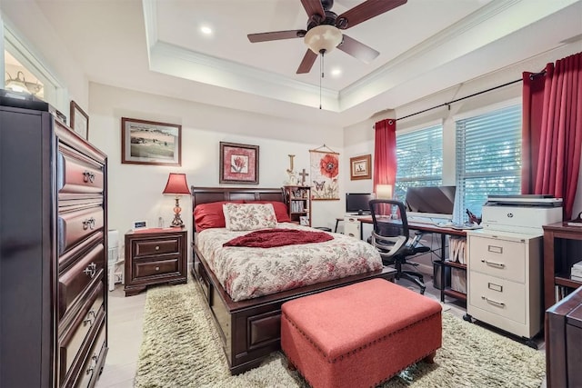 bedroom featuring a tray ceiling, ceiling fan, and crown molding