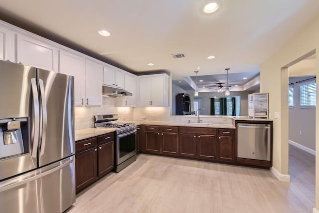 kitchen with sink, light wood-type flooring, white cabinetry, and stainless steel appliances