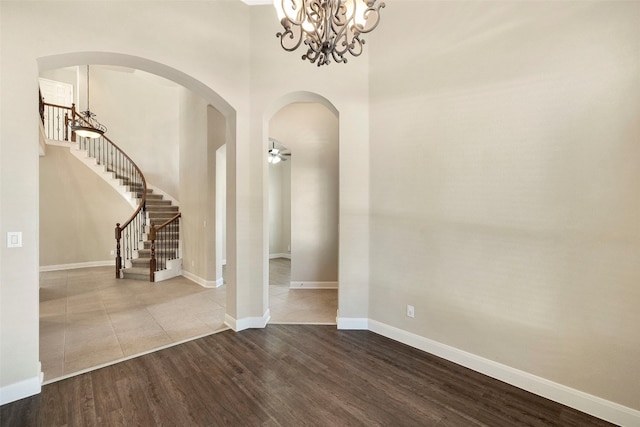 entrance foyer featuring hardwood / wood-style flooring and ceiling fan with notable chandelier