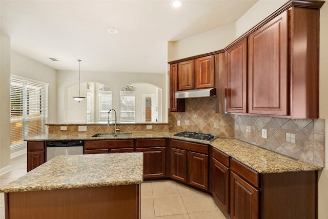 kitchen with appliances with stainless steel finishes, sink, backsplash, pendant lighting, and light tile patterned floors