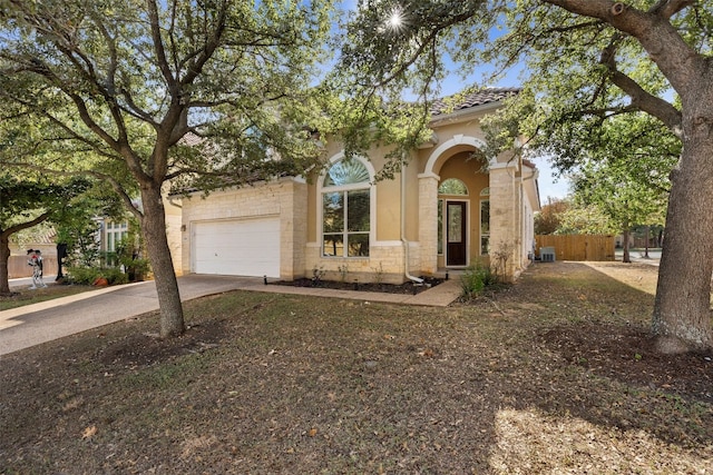 view of front of house featuring central AC unit and a garage