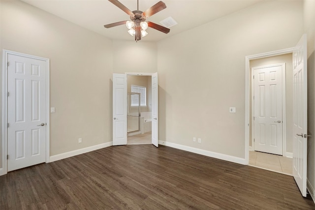 unfurnished bedroom with dark hardwood / wood-style floors and ceiling fan