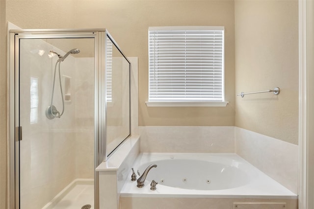 bathroom featuring shower with separate bathtub