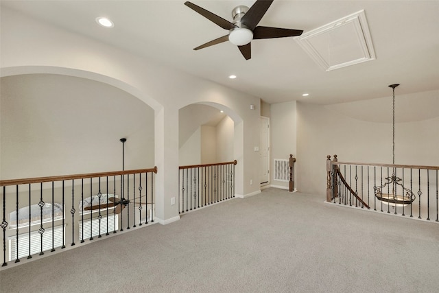 carpeted empty room featuring vaulted ceiling and ceiling fan